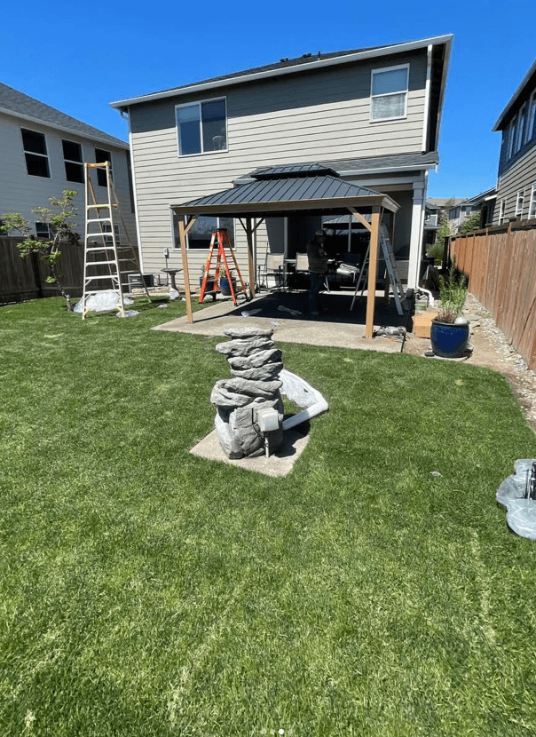 Completed backyard renovation with patio cover and lawn in Tacoma WA